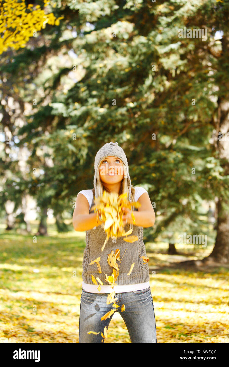 A teenage girl throwing leaves Stock Photo Alamy