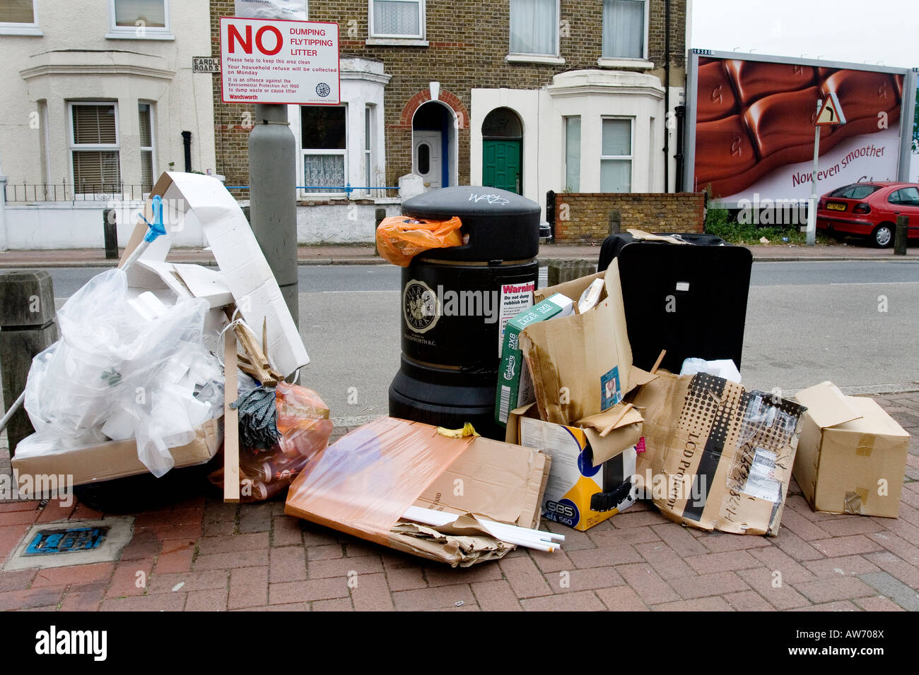 Fly tipping next to a No Fly Tipping sign Stock Photo - Alamy