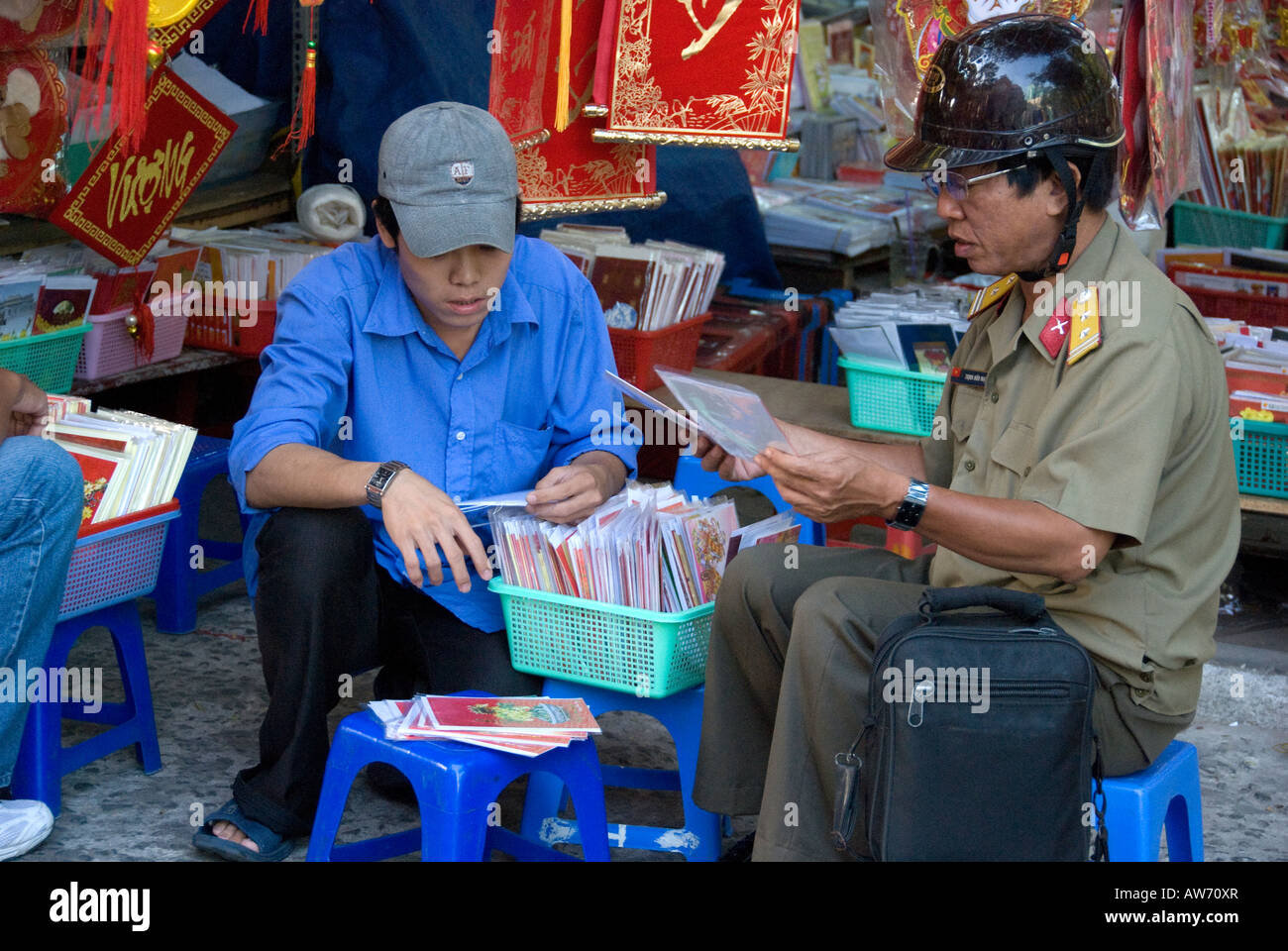 A Vietnamese Army Officer selecting cards to send for the Vietnamese Lunar New Year 'Tet' Stock Photo