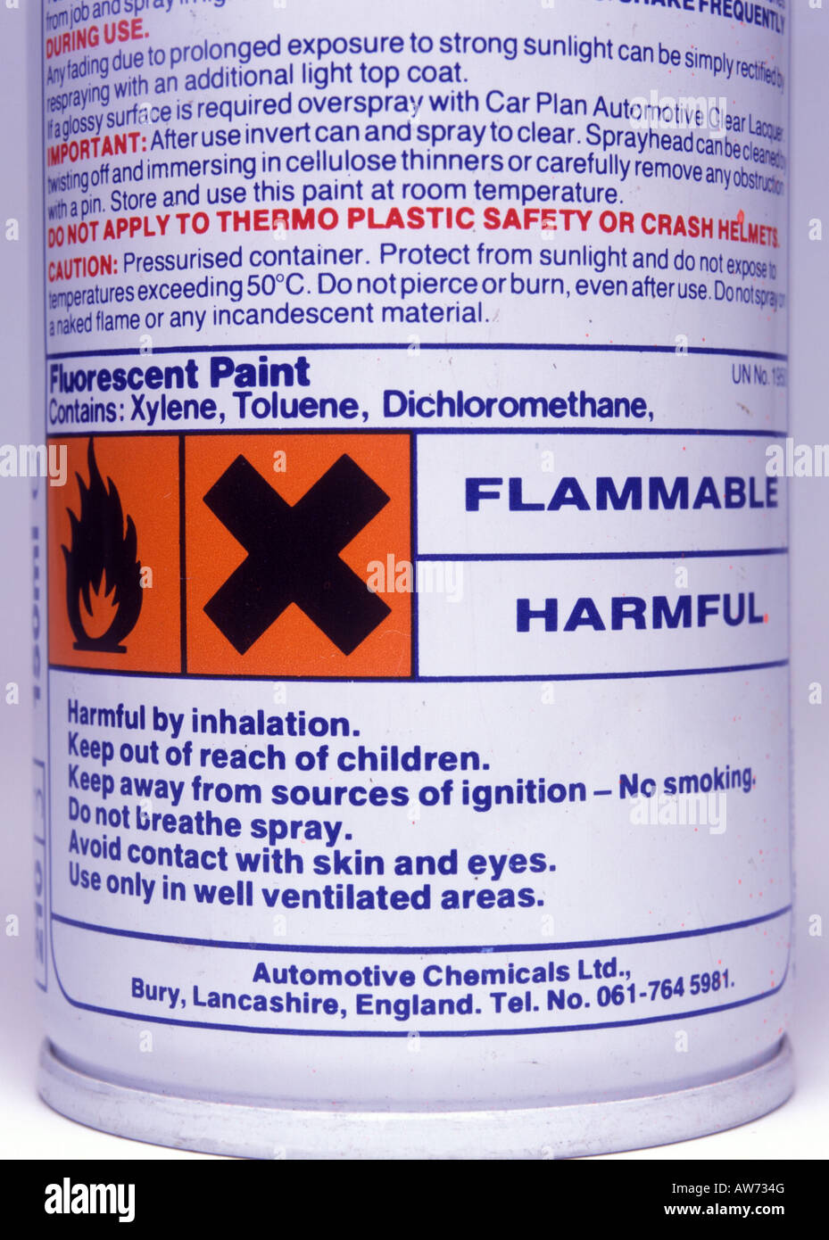 Hazard label on fluorescent paint can Stock Photo