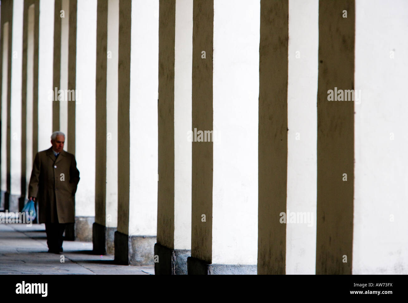 Walkers in Turins colonnades Turin Italy Stock Photo