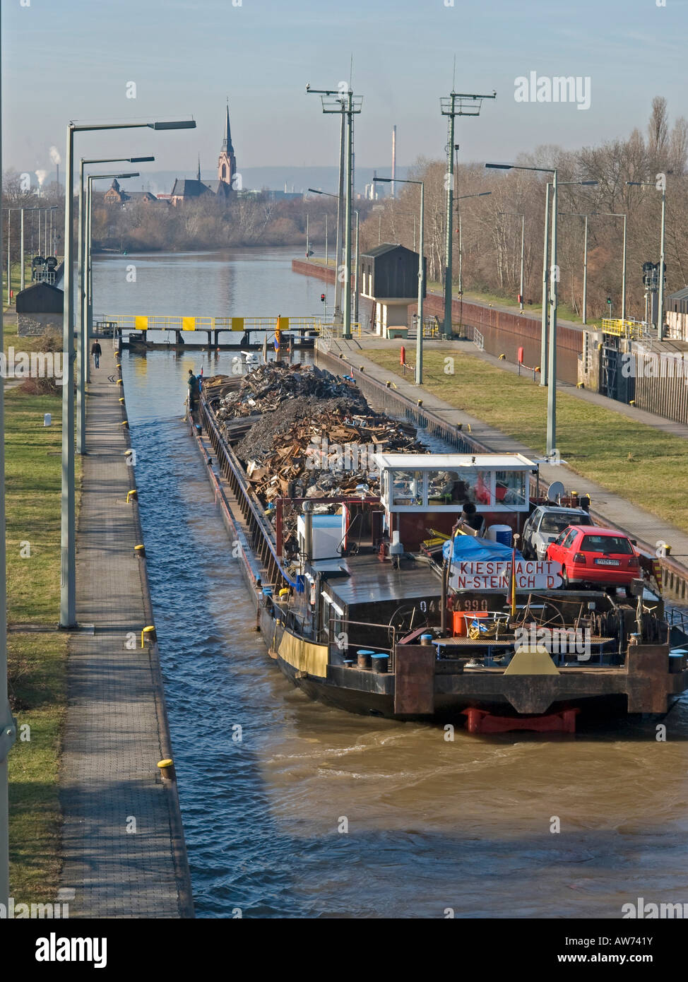 collecting old used metal iron reusable material transport of discarded metall for recycling with a barge on the river Main Stock Photo