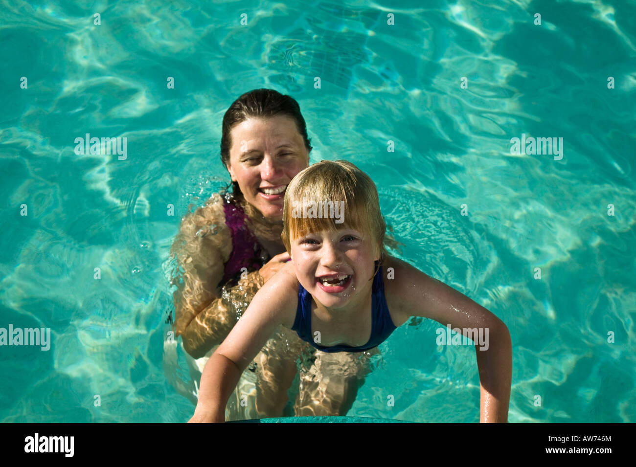 Mom and daughter in swimming pool San Diego, California, USA Stock Photo