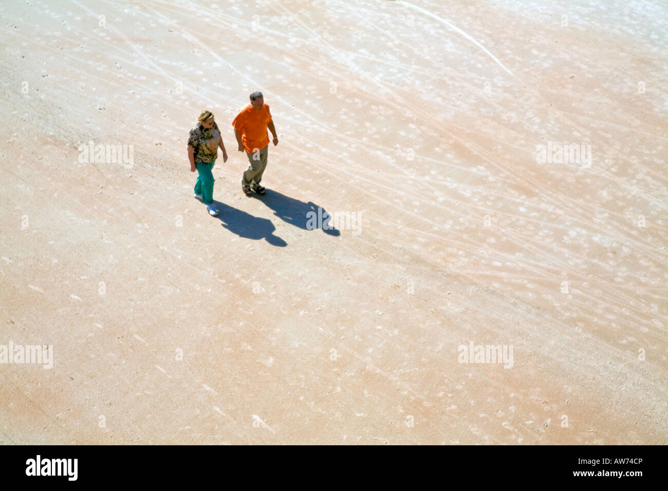 Two People walking on the beach at Daytona Beach Florida USA Stock Photo