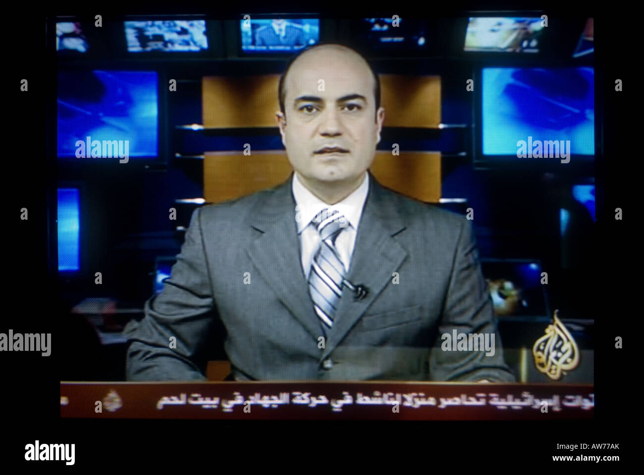 TV screen shot of a news anchor broadcasting live on Al Jazeera' also Aljazeera or JSC Stock Photo