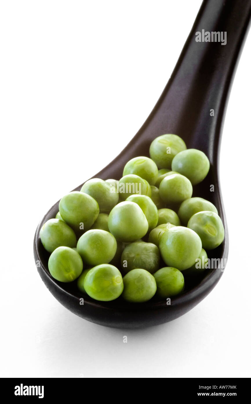 fresh peas in black spoon Stock Photo