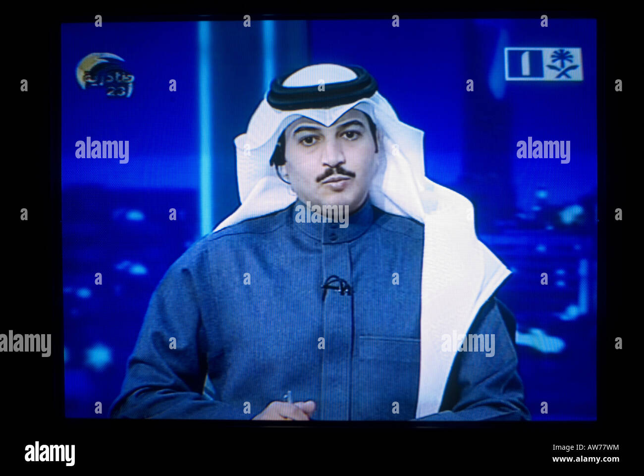 TV screen shot of a Saudi newscaster wearing a traditional Keffiyeh headdress broadcasting live on 'Saudi TV', Saudi Arabia Stock Photo