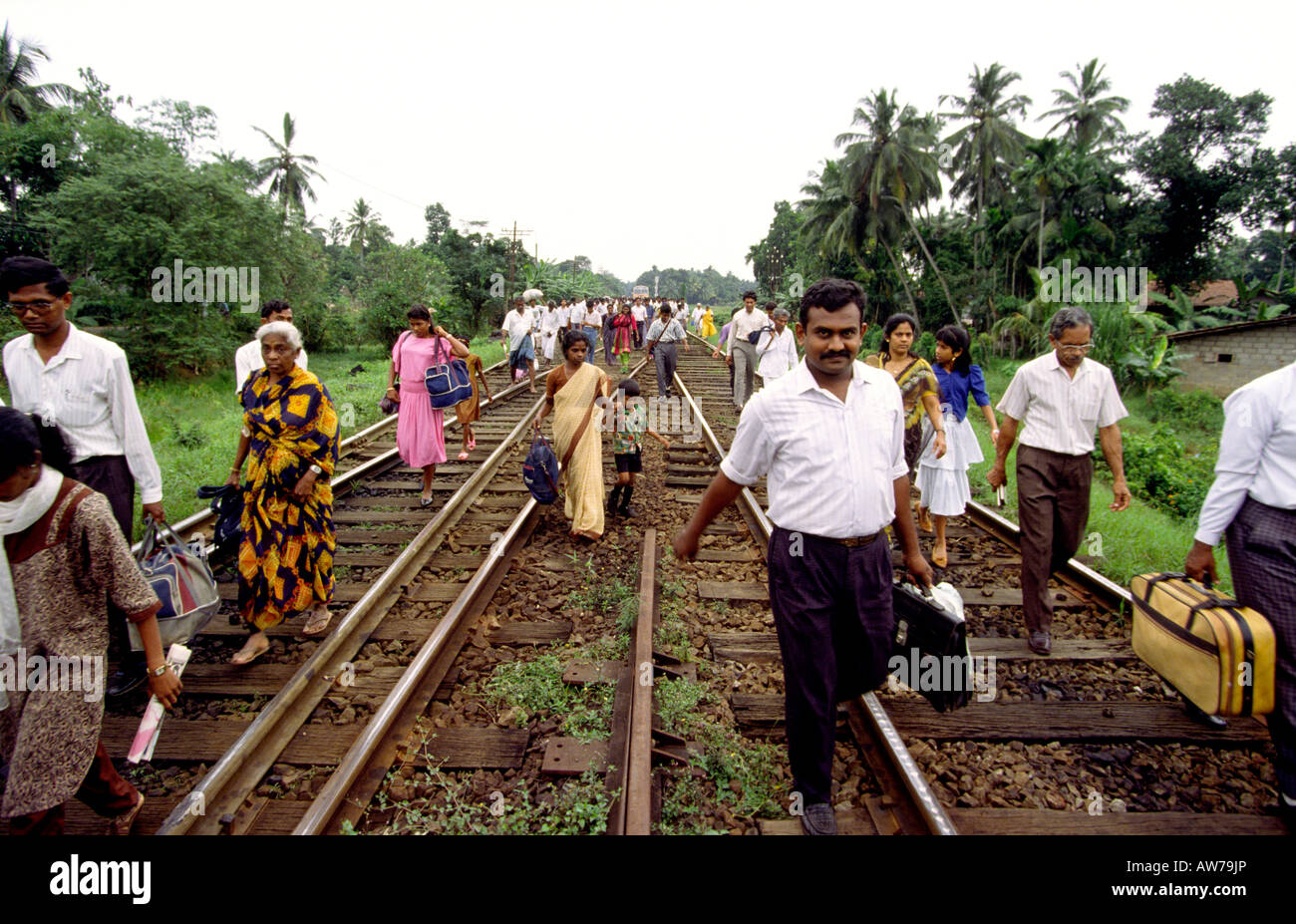 Sri Lanka transport passengers from derailed Colombo to Kandy train walking down track Stock Photo