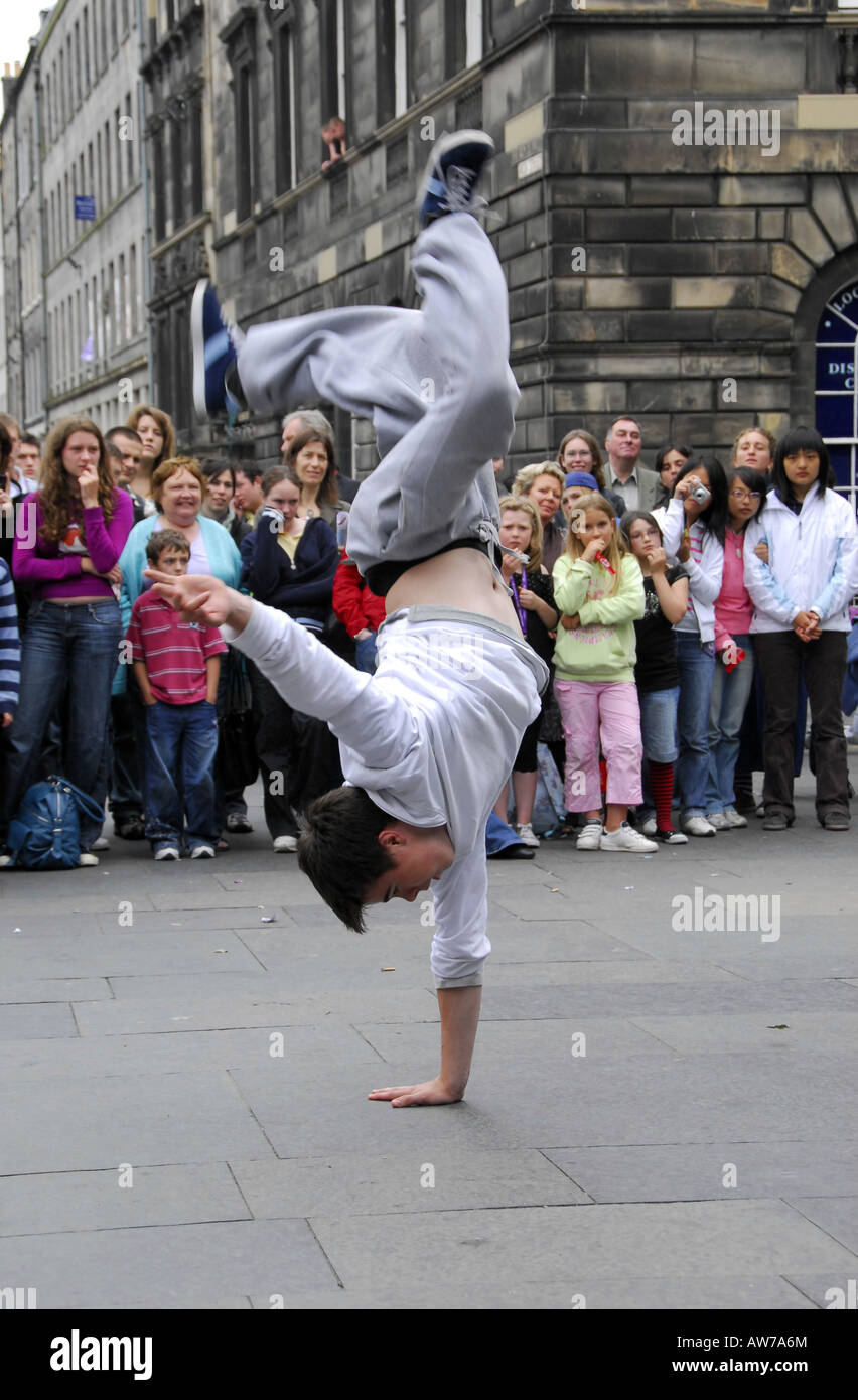 Youth breakdancing on city streets infront of crowds Stock Photo