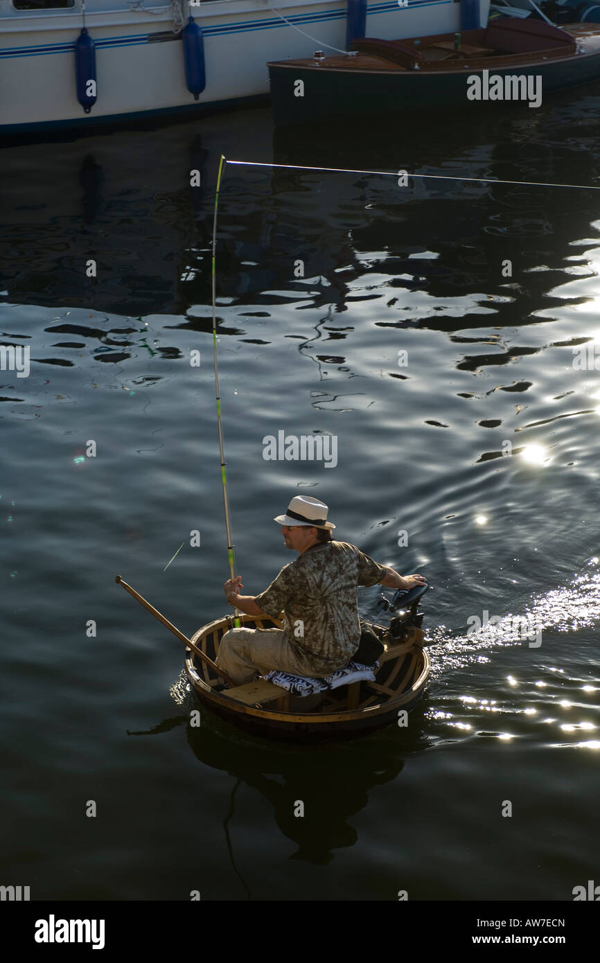 Fishing on the river Great Ouse from a modern Coracle Stock Photo - Alamy