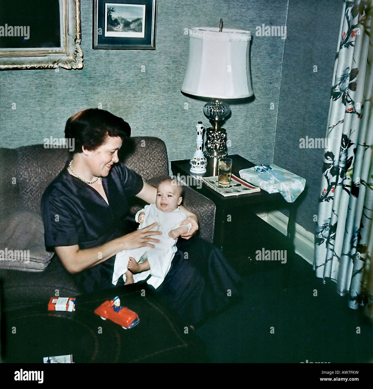 USA Portrait Mother Holding  Baby Boy, at Home in 'Living Room' Old Family Archives Vintage 1950s Retro Photo, lifestyle Stock Photo