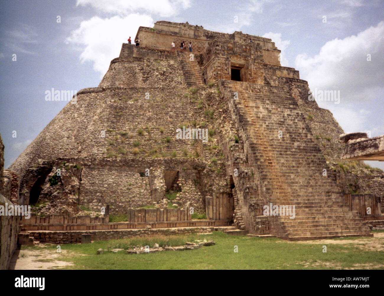 People climbing to top of big steep Maya stone pyramid Uxmal Yucatan Mexico Central Latin America Stock Photo