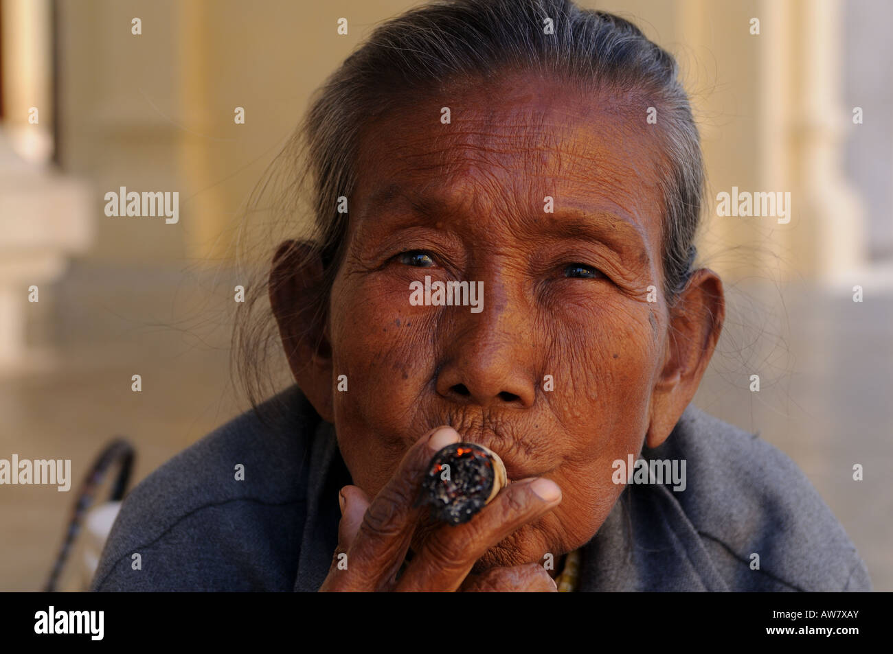 Old woman smokes a Marihuana Cigar Cigarette Bagan Myanmar Asia Stock Photo