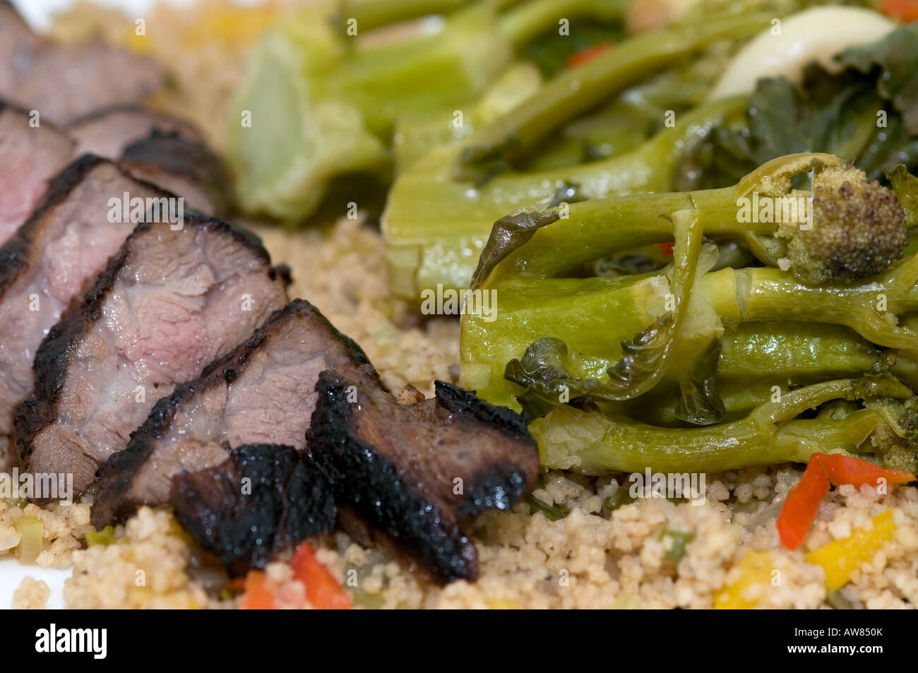 Lamb Fillet and Purple Broccoli on a bed of Cous Cous Stock Photo