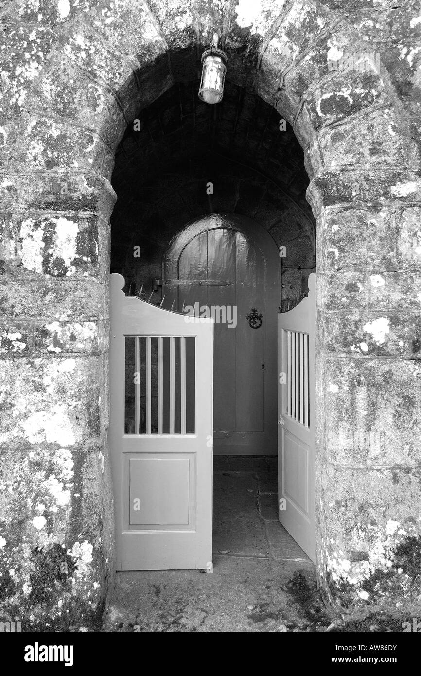 Main entrance of Holy Trinity Church at Gidleigh on Dartmoor National Park South Devon England in monochrome Stock Photo