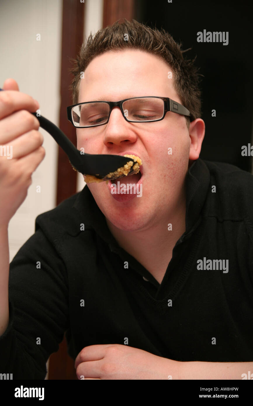Man eating apple crumble Stock Photo Alamy