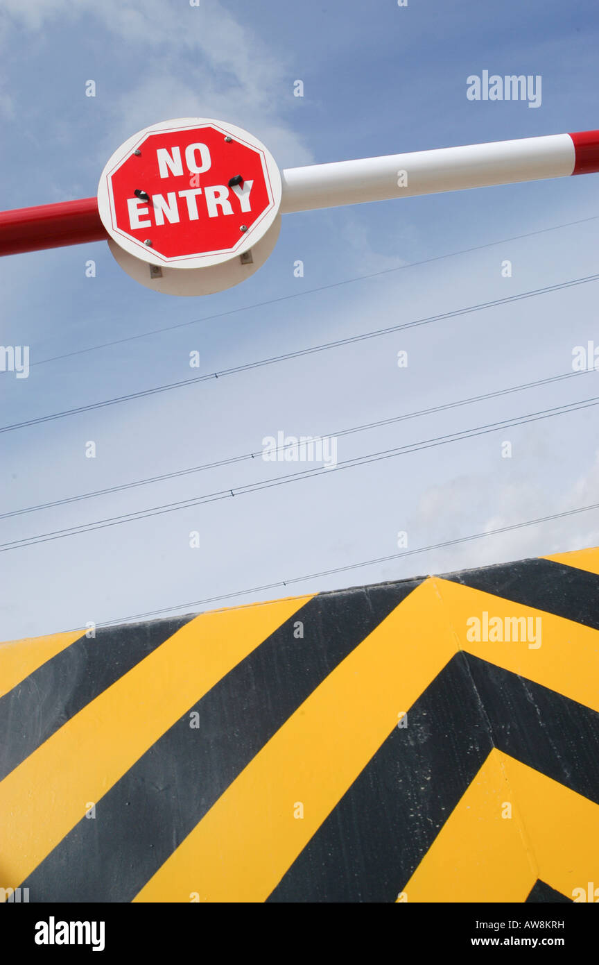 no entry sign on a barrier over a ramp at entrance to commerical ...