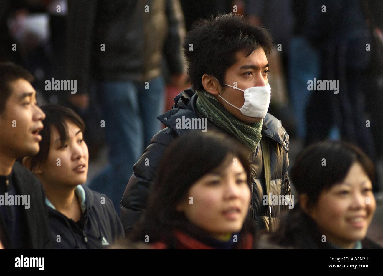 Pollution forces many to wear facemasks in the streets of central Beijing. Stock Photo