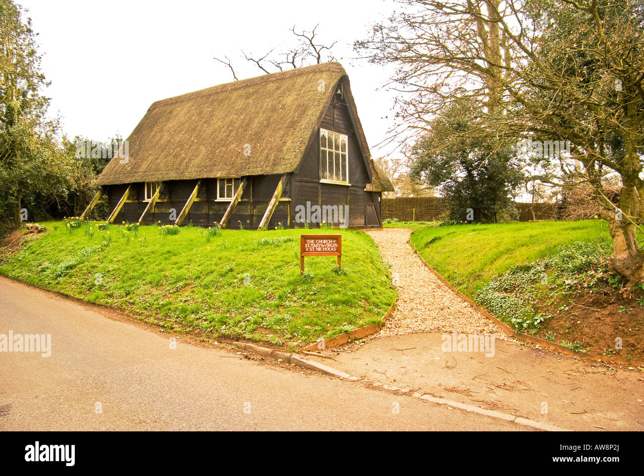 Roadside view of the wood and thatch church of St Mary the Virgin and