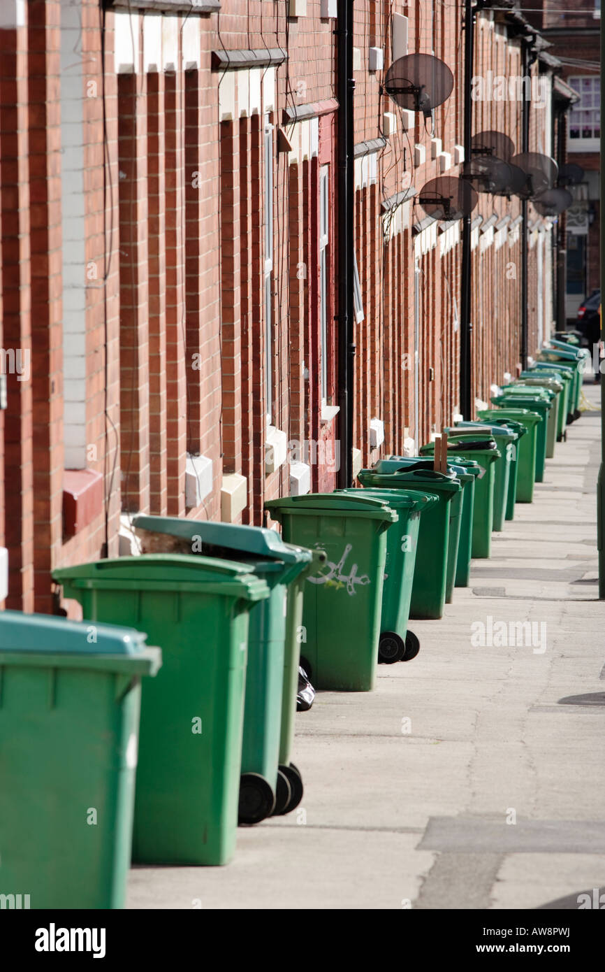 A row of green refuse bins waiting to be collected on a pavement in Nottingham, UK Stock Photo