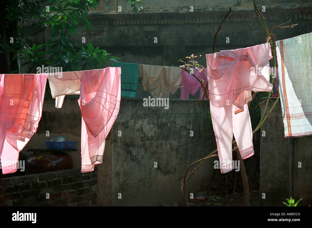 Pink robes hanging up to dry at Zayar Theingi Nunnery in the Sagaing Hills near Mandalay, Myanmar (Burma) Stock Photo