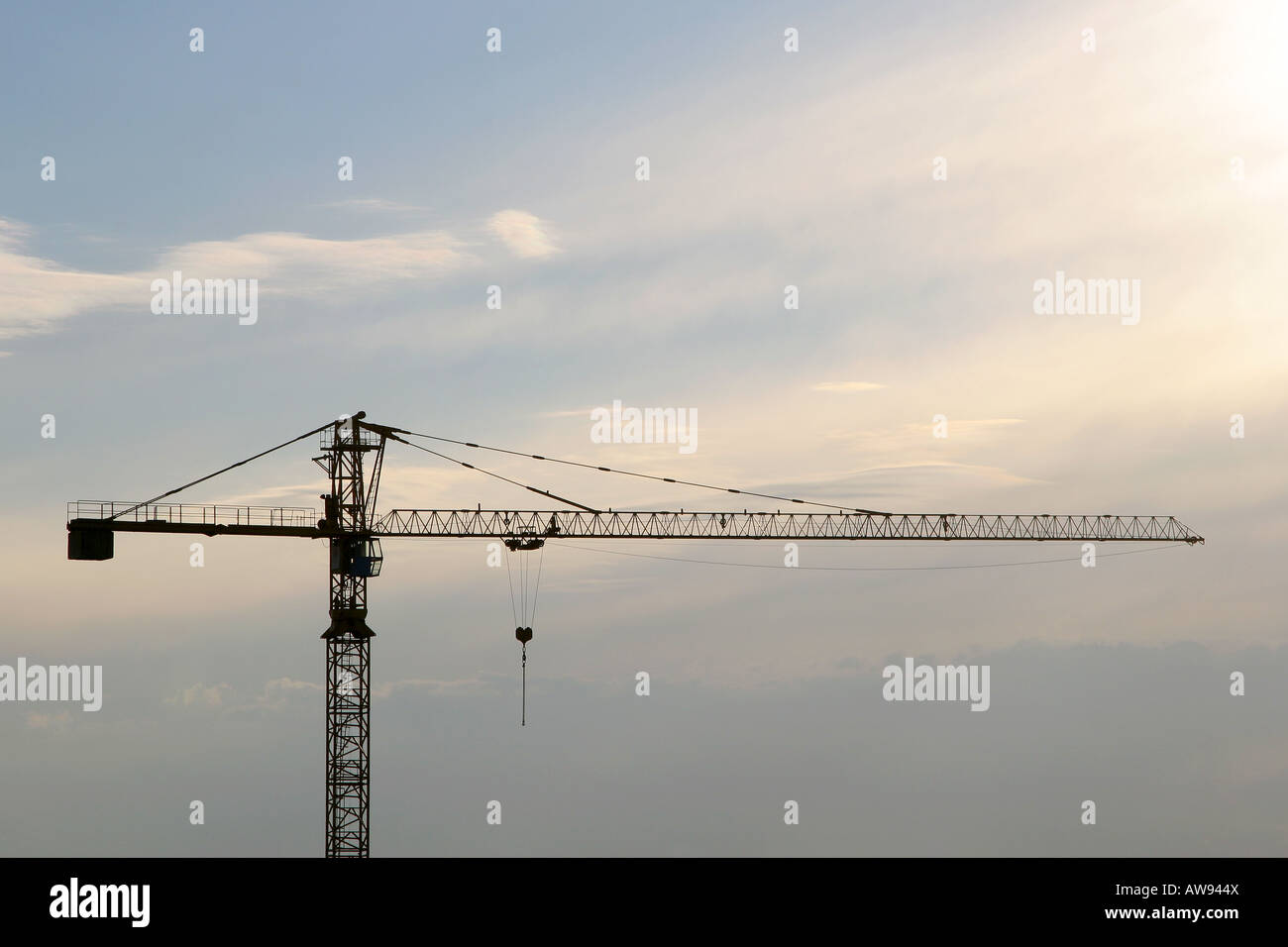 A slewing crane silhouette with cloudy sky Stock Photo - Alamy