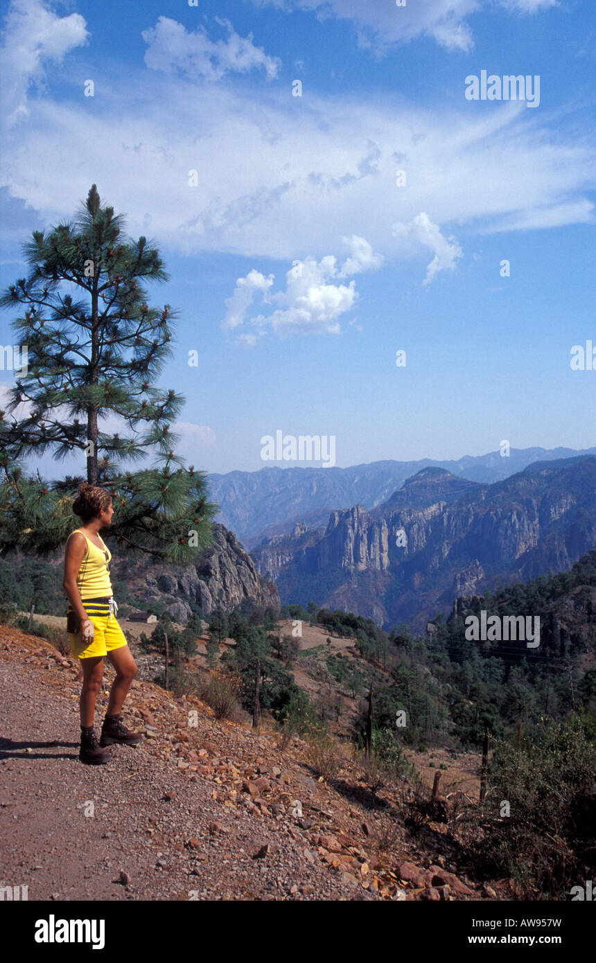 Young hispanic woman looking into the Copper Canyon or Barranca del