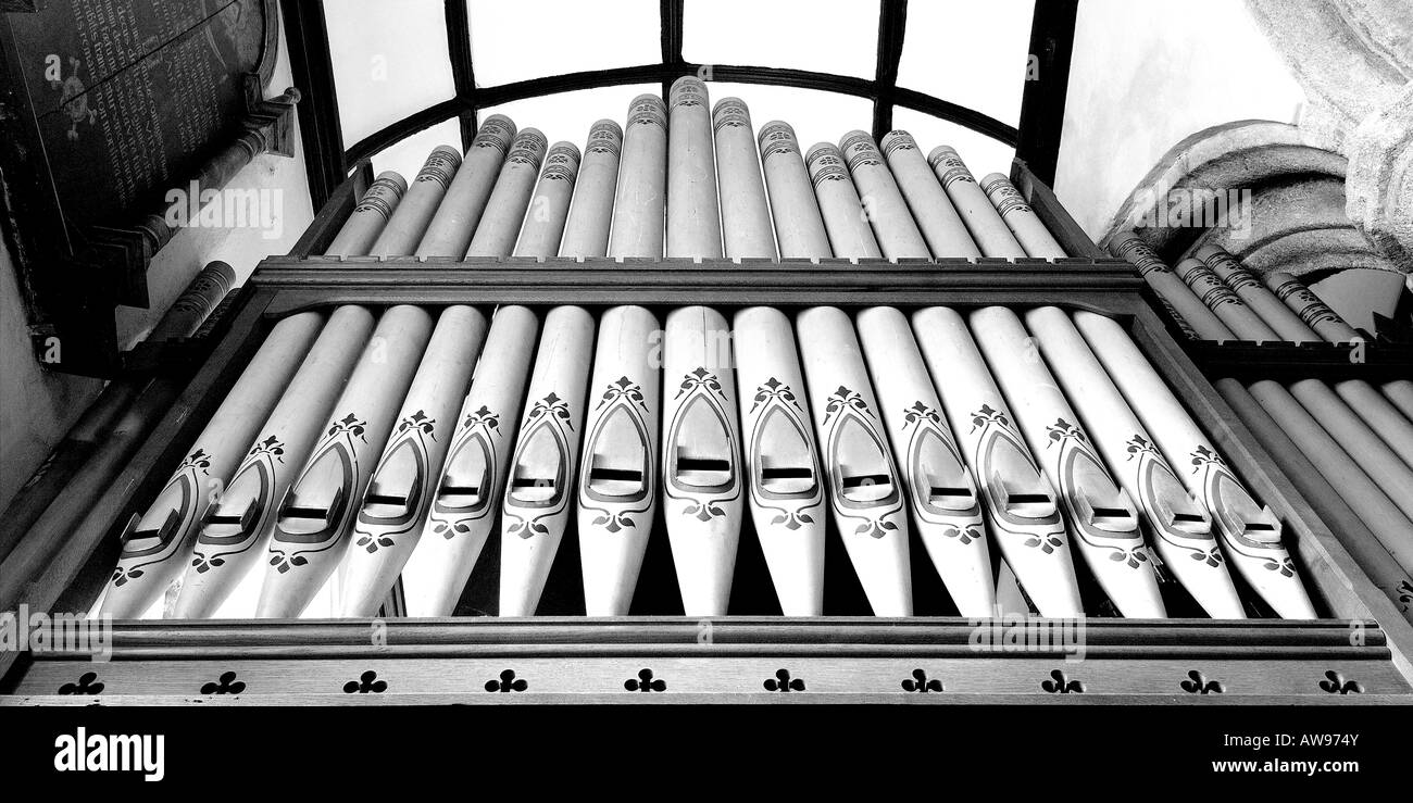 Decorative organ pipes in St James Church at Christow on Dartmoor South Devon from below in panoramic monochrome Stock Photo
