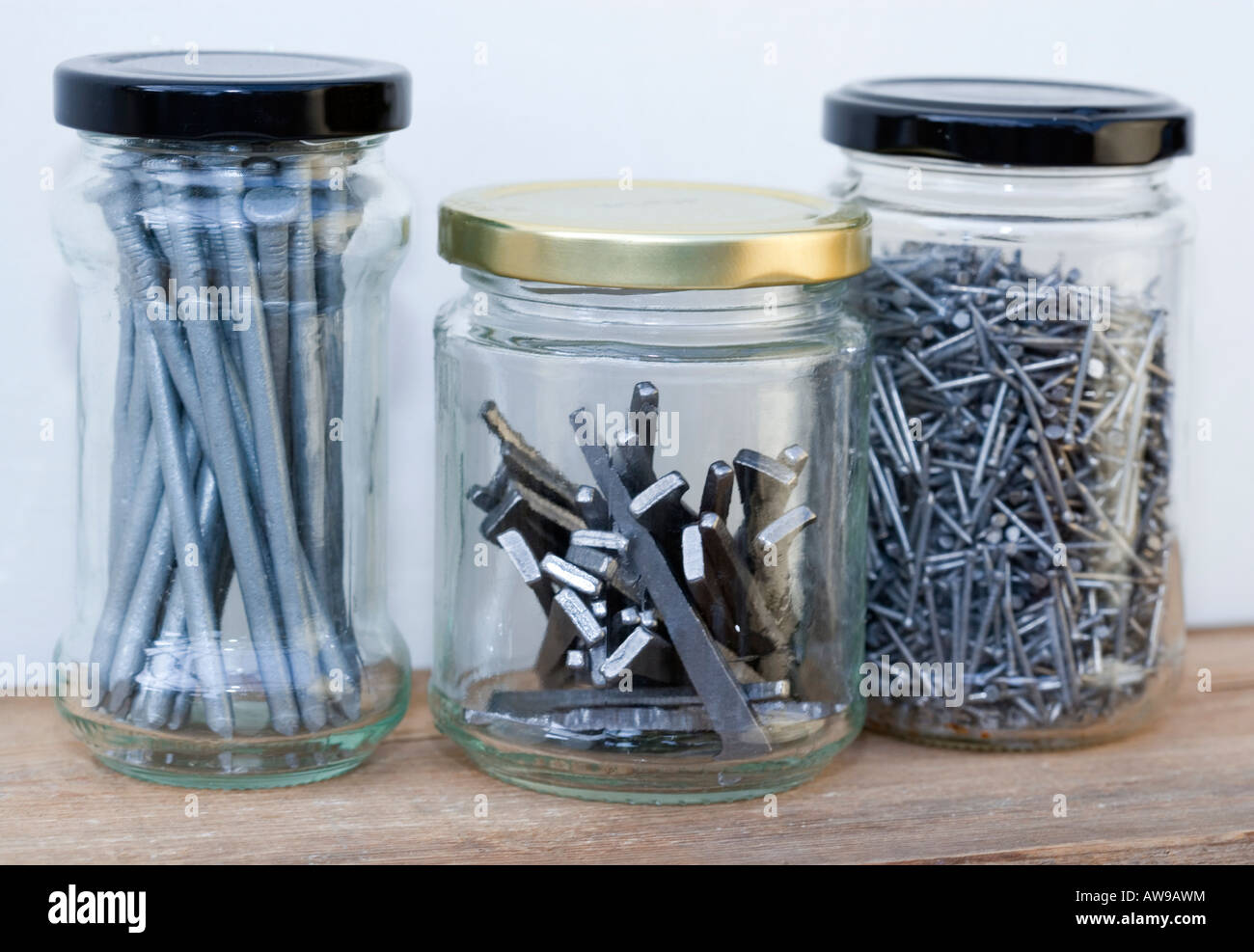 A selection of Nails in old jam jars Stock Photo