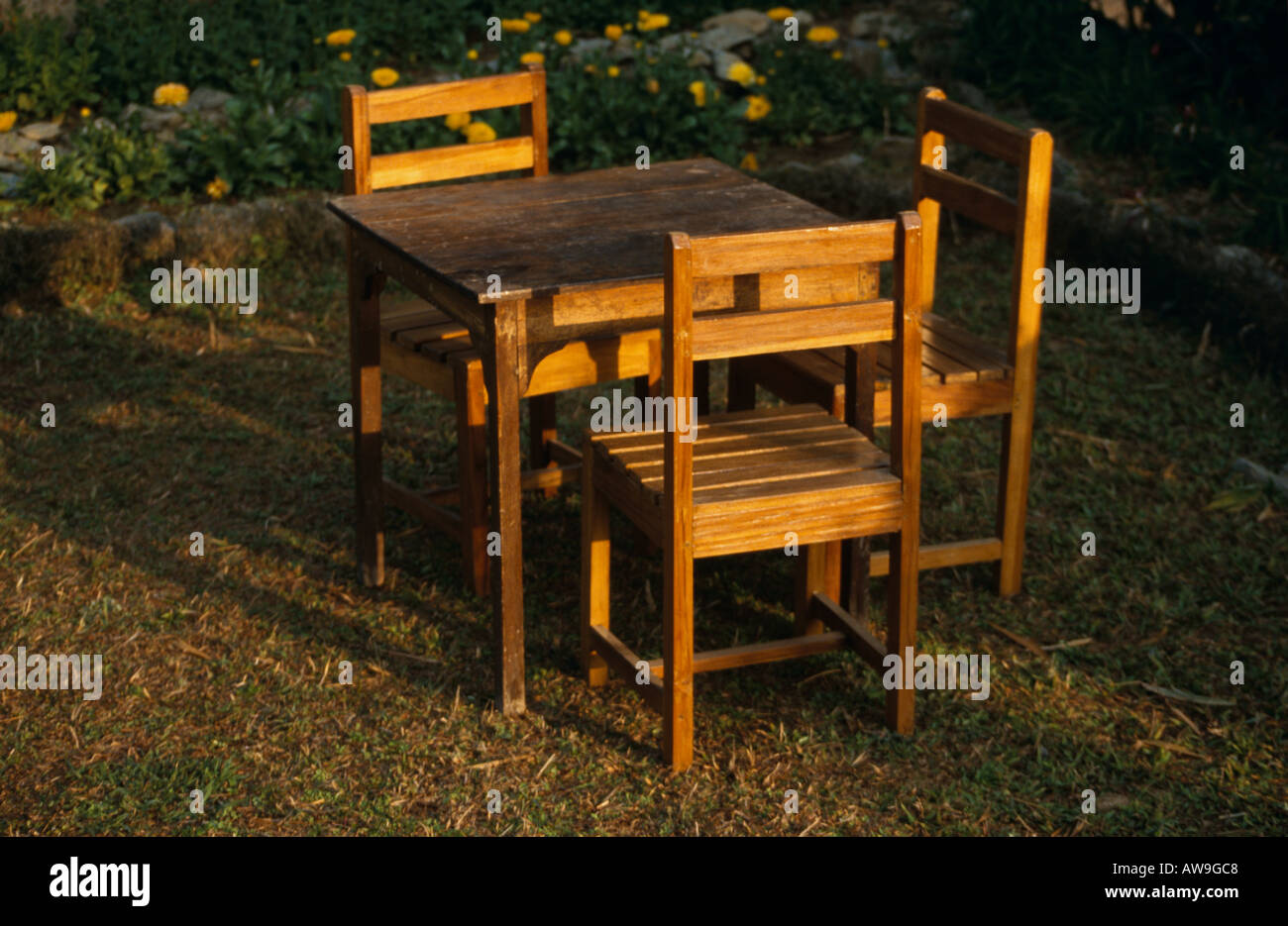 Table & chairs in sunlight at Samthar Farmhouse, Samthar Plateau, hills of West Bengal, India Stock Photo