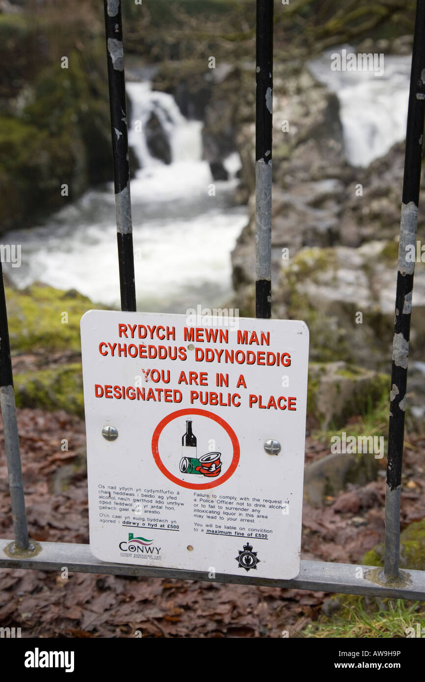 Wales UK No drinking alcohol in designated public place council sign by Afon Conwy River waterfall Stock Photo