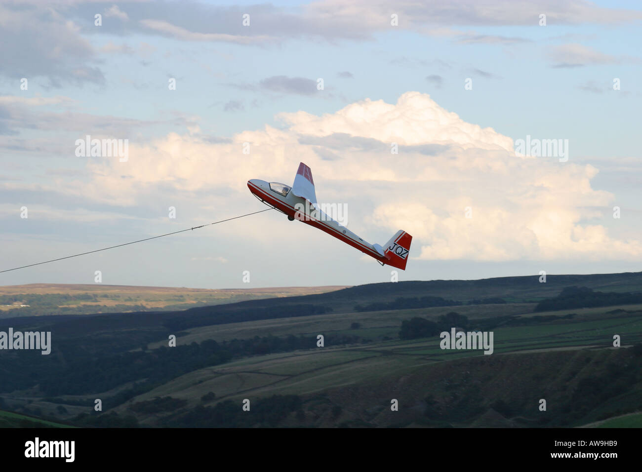 A vintage glider being launched by a winch, viewed from the side Stock