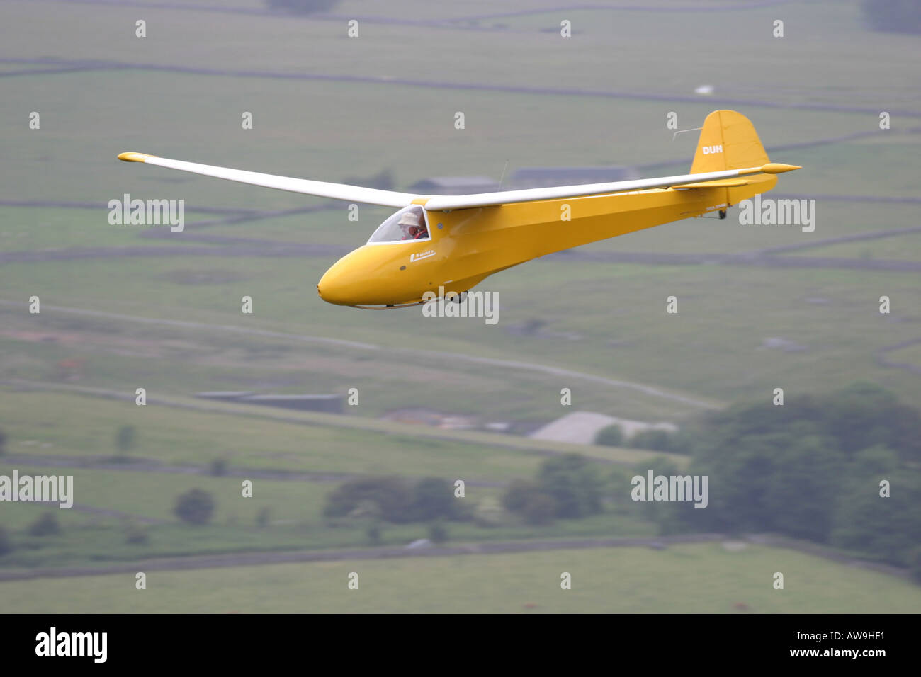 A vintage glider soaring in ridge lift over the Derbyshire countryside