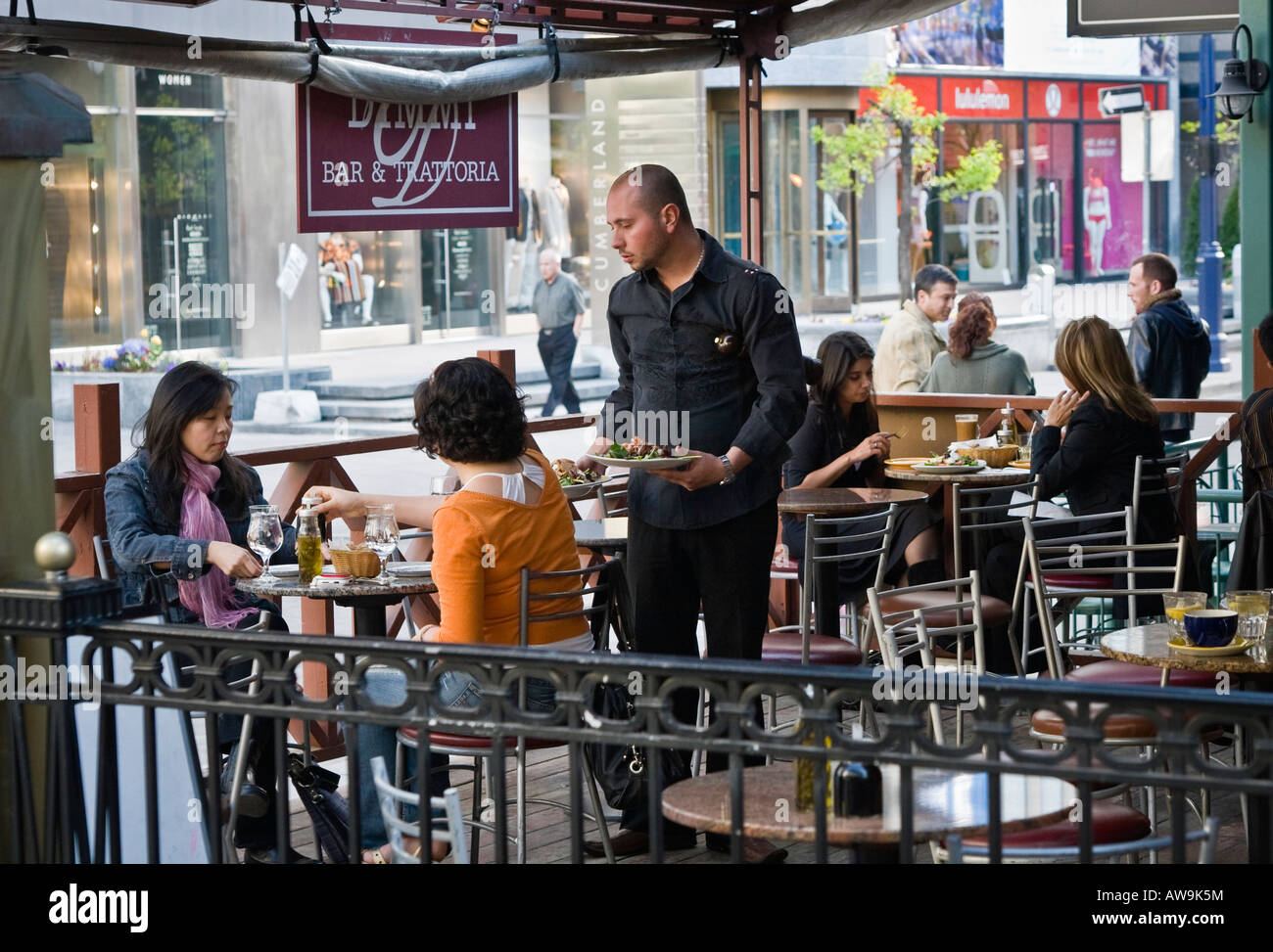 People dining at outdoor restaurant patio (part of 2 image sequence). Stock Photo