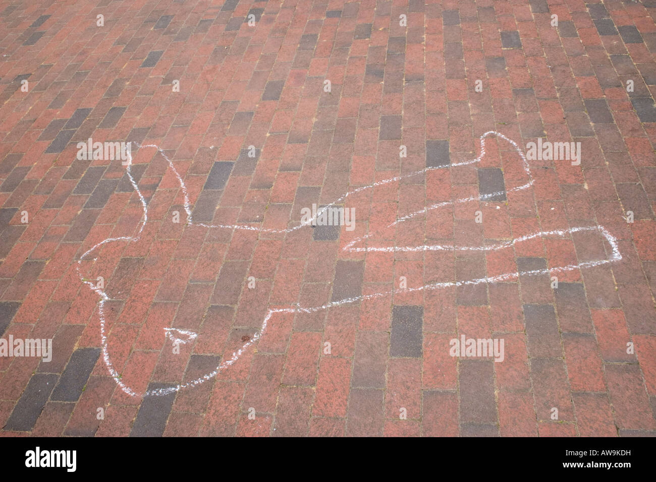 Chalk outline of a body on the pavement Stock Photo