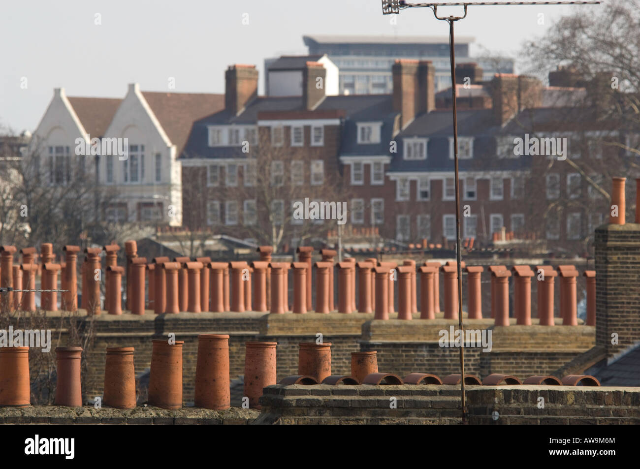 Chimney pots and television aerials in the foreground of a London skyline. Stock Photo