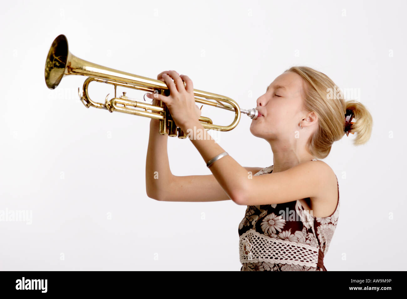 Stock Photograph of a young girl playing the trumpet Stock Photo - Alamy
