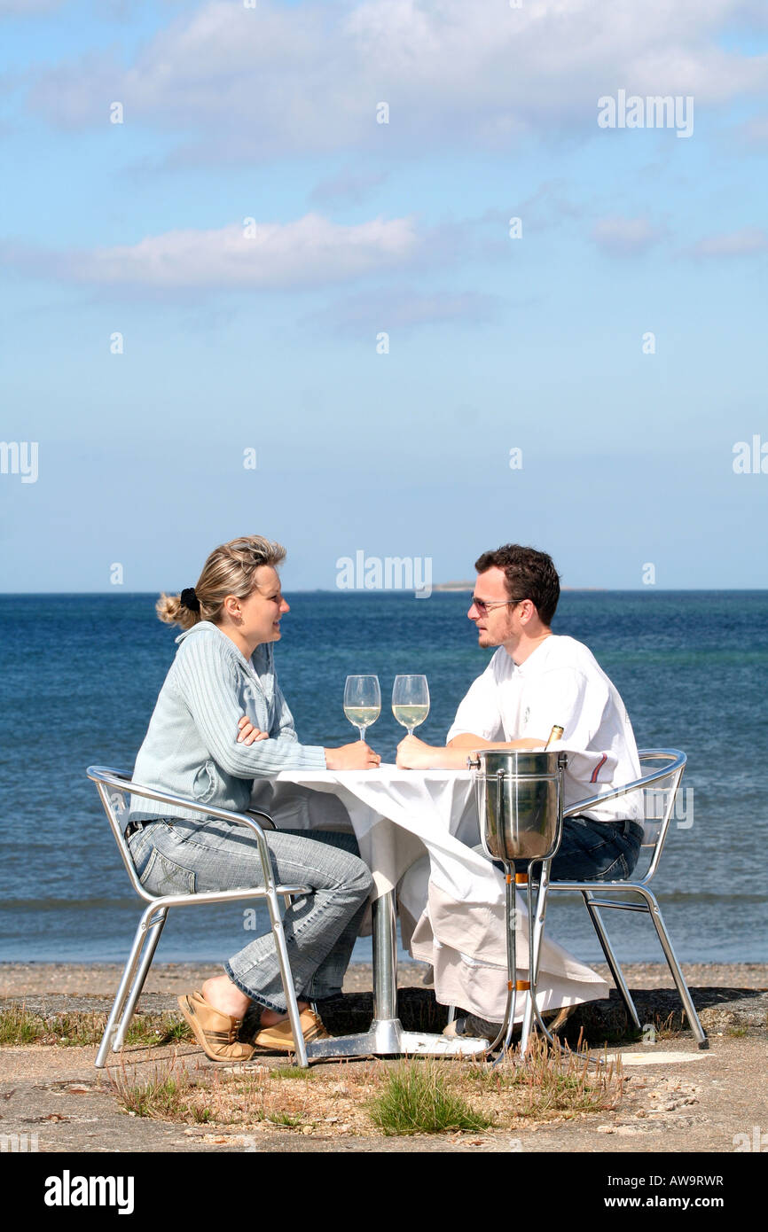 A couple eating with sea view Normandy France Stock Photo