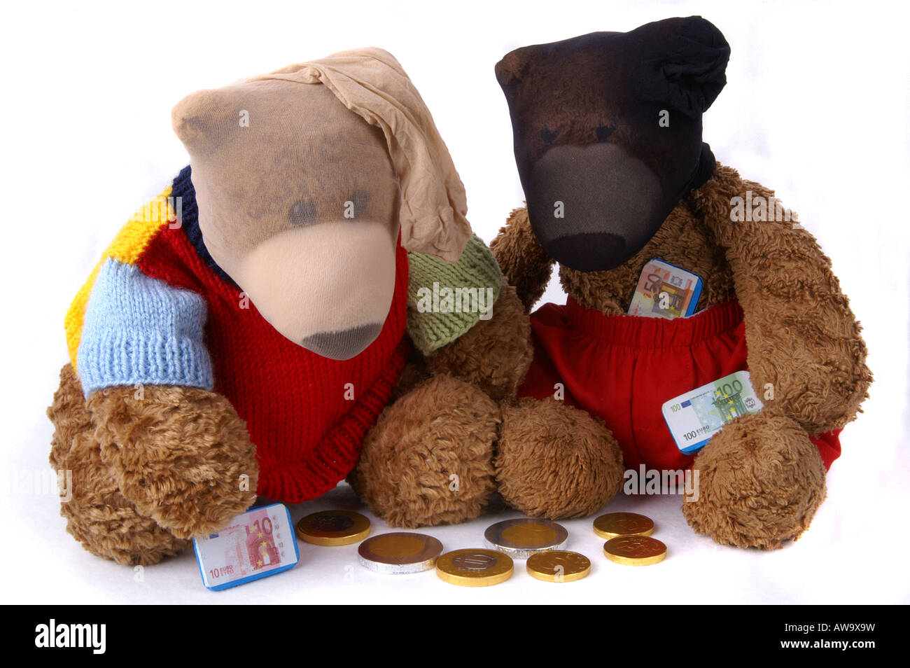 Beary bank robbers wearing stocking masks / Zwei Teddybären mit Strumpfmasken zählen Schokoladengeld Stock Photo