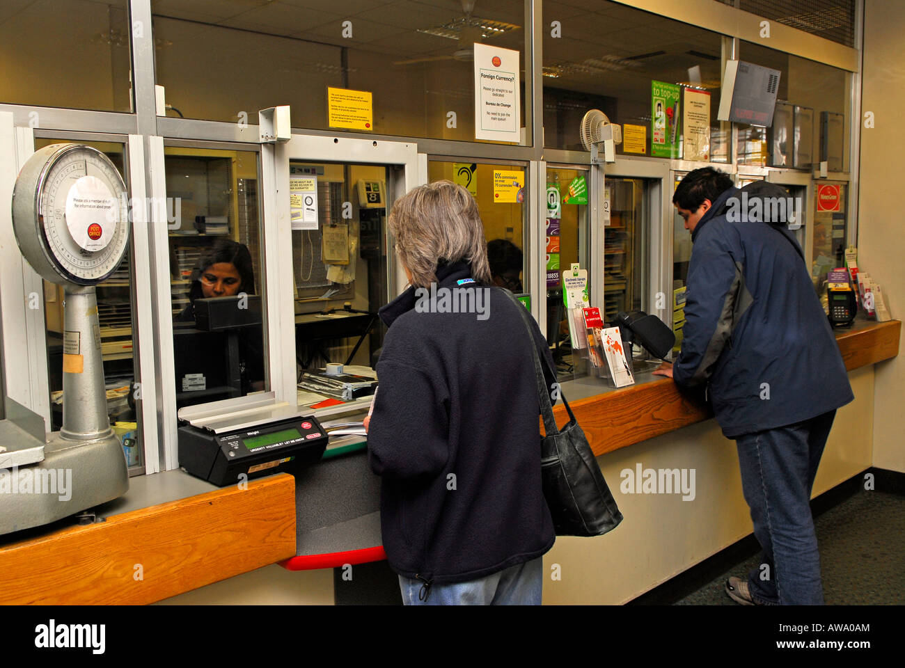 Customers using their local post office, High Street, New Malden, Surrey, UK. Stock Photo