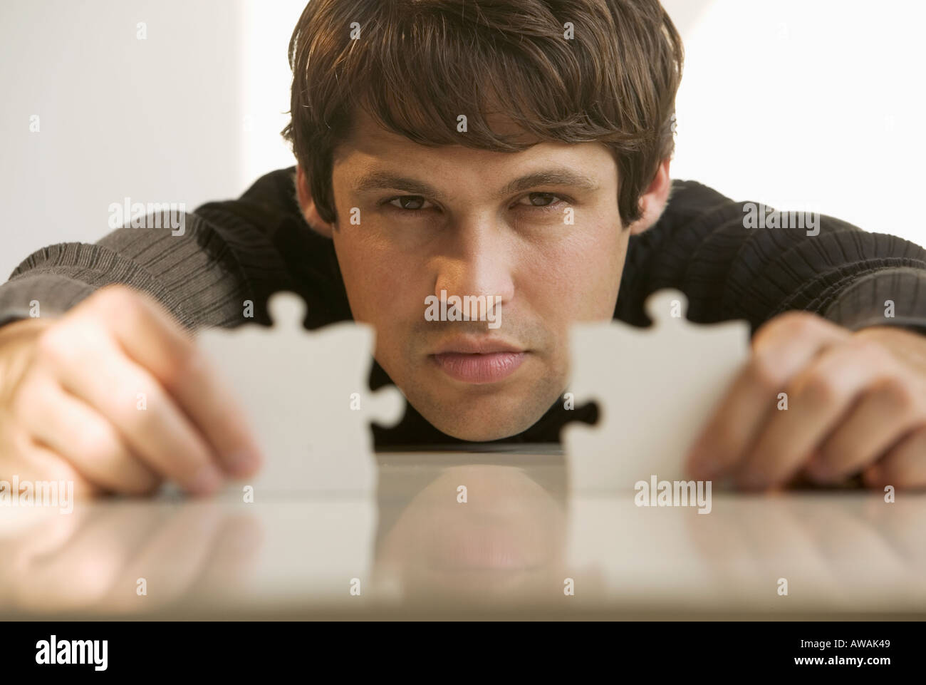 Men putting puzzle pieces together hi-res stock photography and images ...