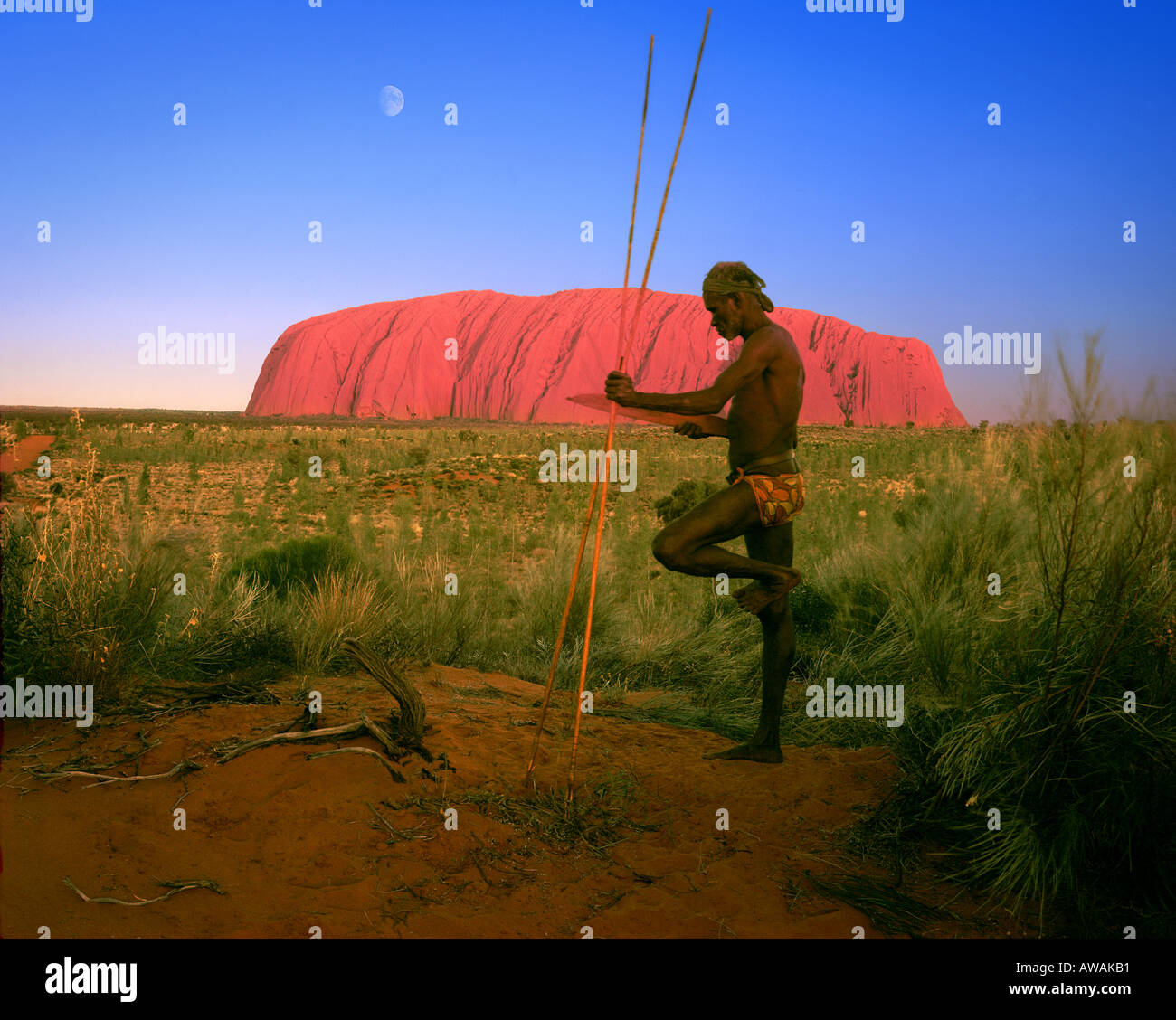 AU - Uluru-Kata Tjuta National Park:  Aborigine at Uluru  (formerly known as Ayers Rock) Stock Photo