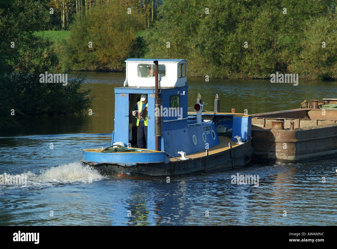 Tug boat pushing commercial canal Traffic on the Aire & Calder