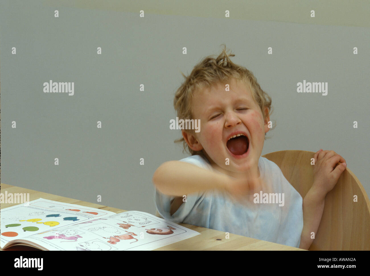 young boy shouting and waving his hands Stock Photo