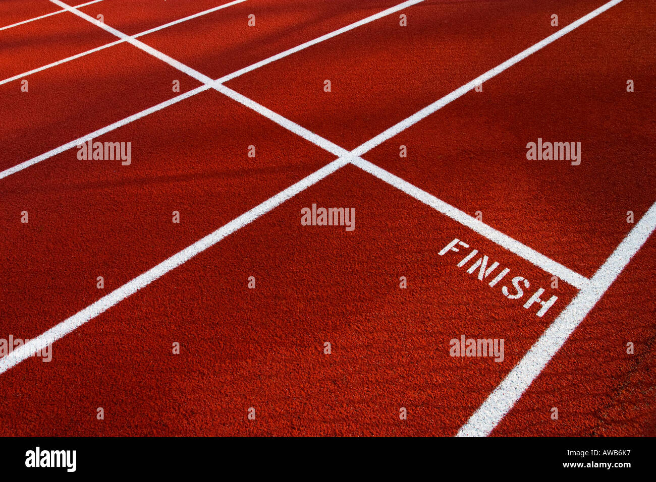 White Finish line and word Finish on red running track with while lines