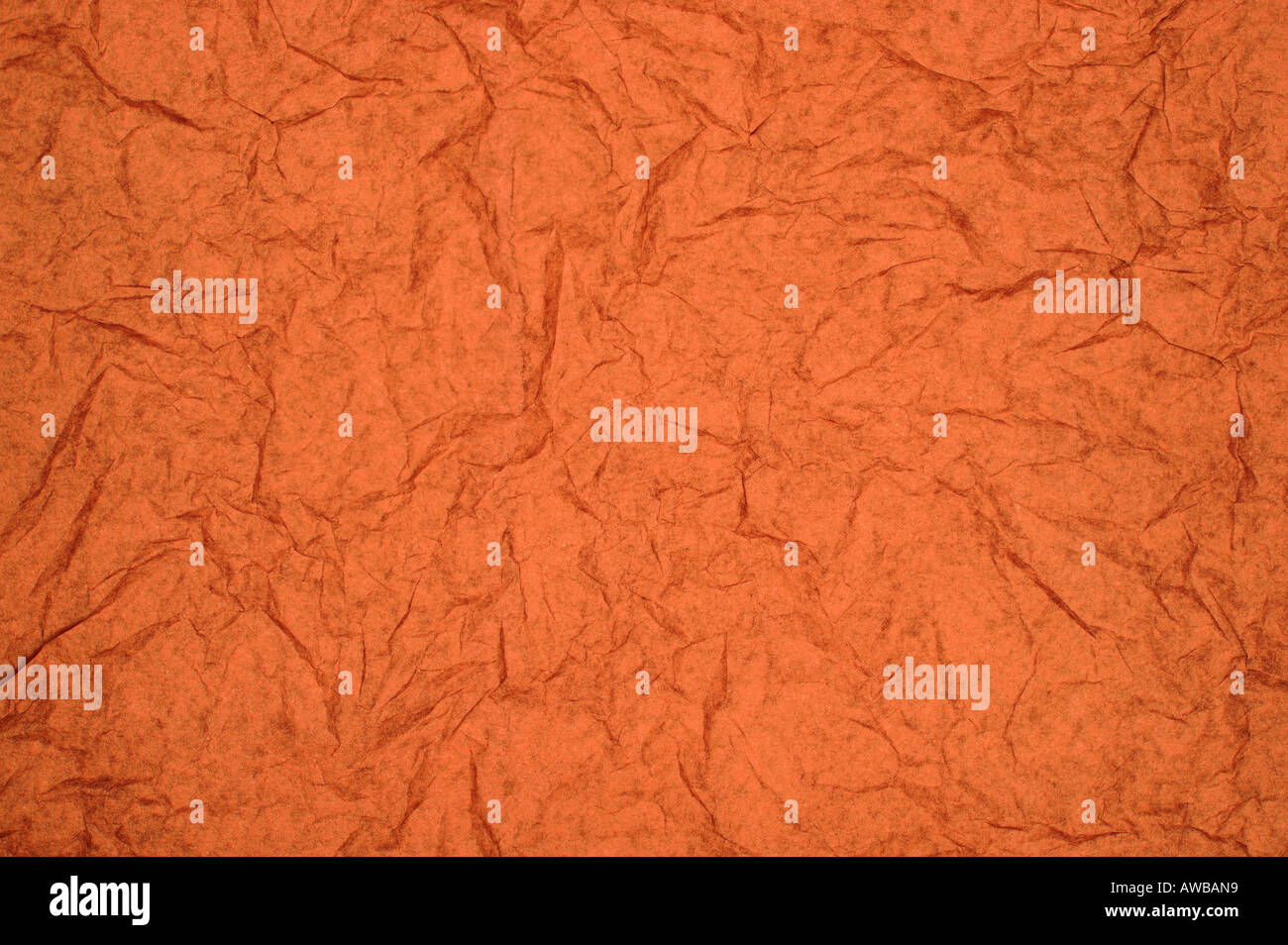 ABSTRACT RANDOM BACKGROUND OF CREASED CRUMPLED ORANGE RED TISSUE PAPER Stock Photo