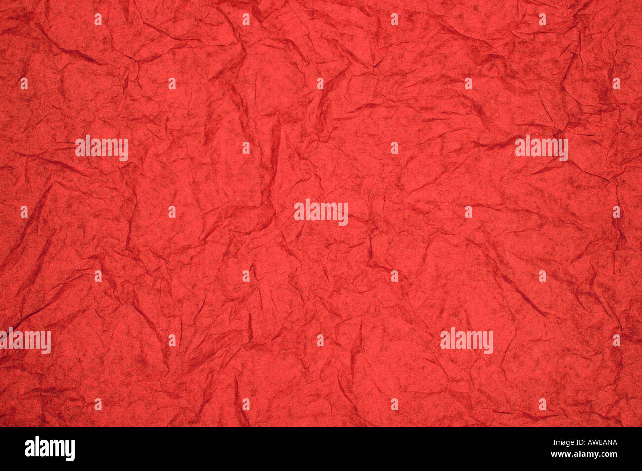 ABSTRACT RANDOM BACKGROUND OF CREASED CRUMPLED BRIGHT RED TISSUE PAPER Stock Photo