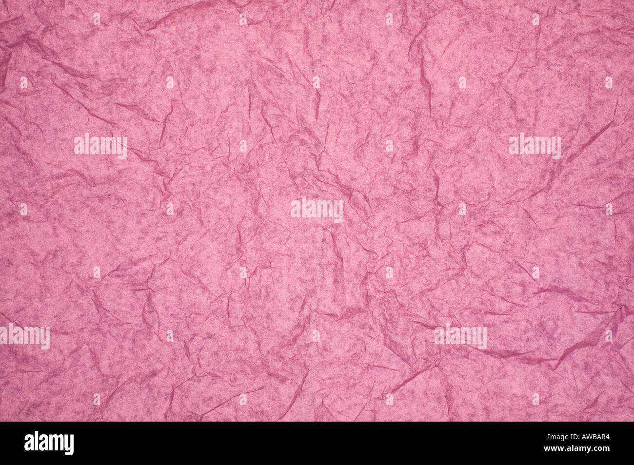 ABSTRACT RANDOM BACKGROUND OF CREASED CRUMPLED PALE PINK TISSUE PAPER Stock Photo