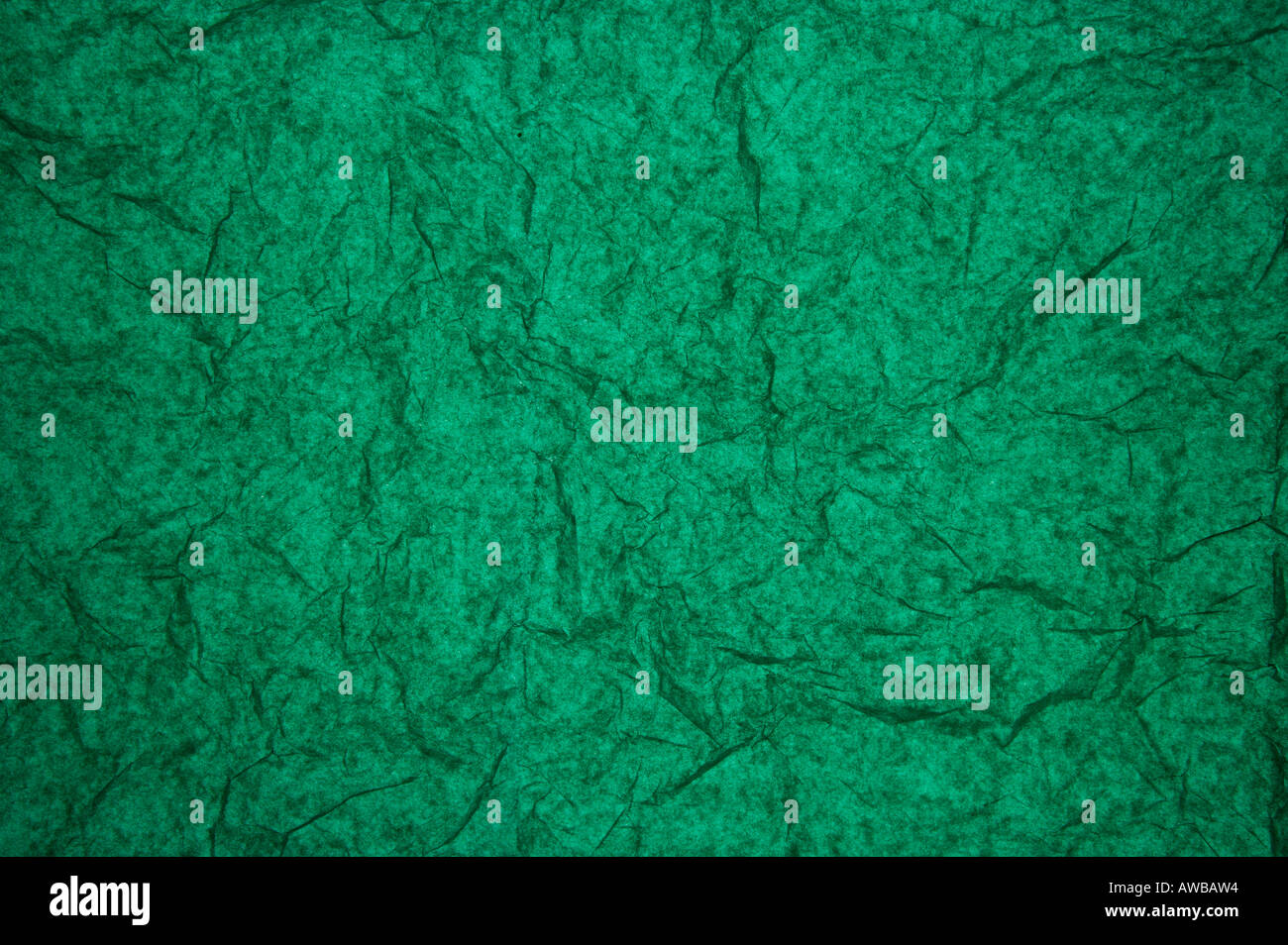 ABSTRACT RANDOM BACKGROUND OF CREASED CRUMPLED DARK EMERALD GREEN TISSUE PAPER Stock Photo