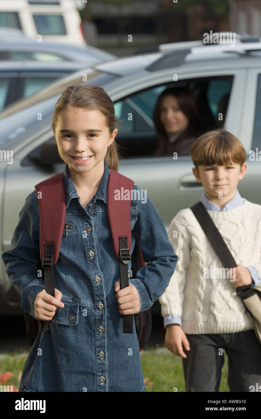 Mother dropping children off at school Stock Photo